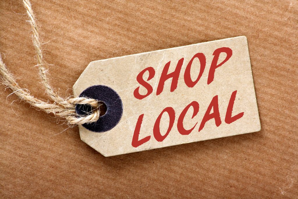 Shop Local written on a hang tag with twine to attach to article.